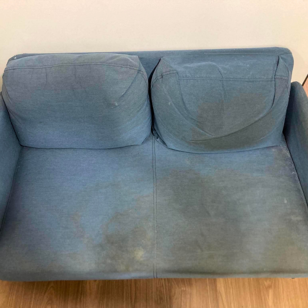 Blue loveseat before deep clean